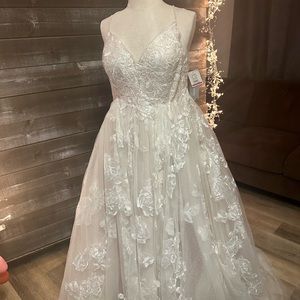 Crisscrossed spaghetti strapped ball gown wedding dress